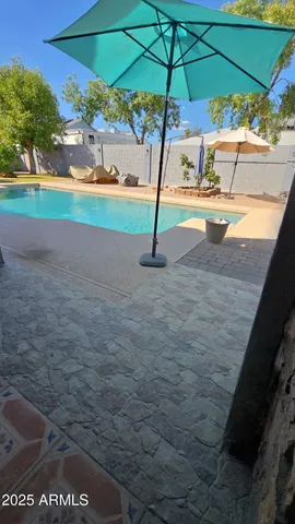 a front view of a house with a garden and a car