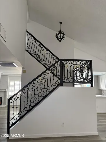 a view of staircase with lots of frames on wall