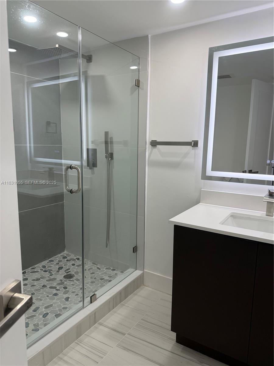 16251 Golf Club Road, Unit 204 Weston, FL 33326 - Photo 13 of 40 a bathroom with a shower sink and mirror