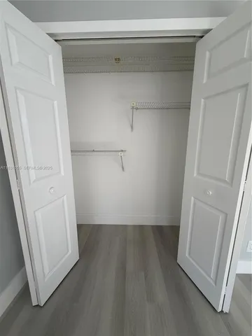 a living room with furniture gym equipment and a chandelier