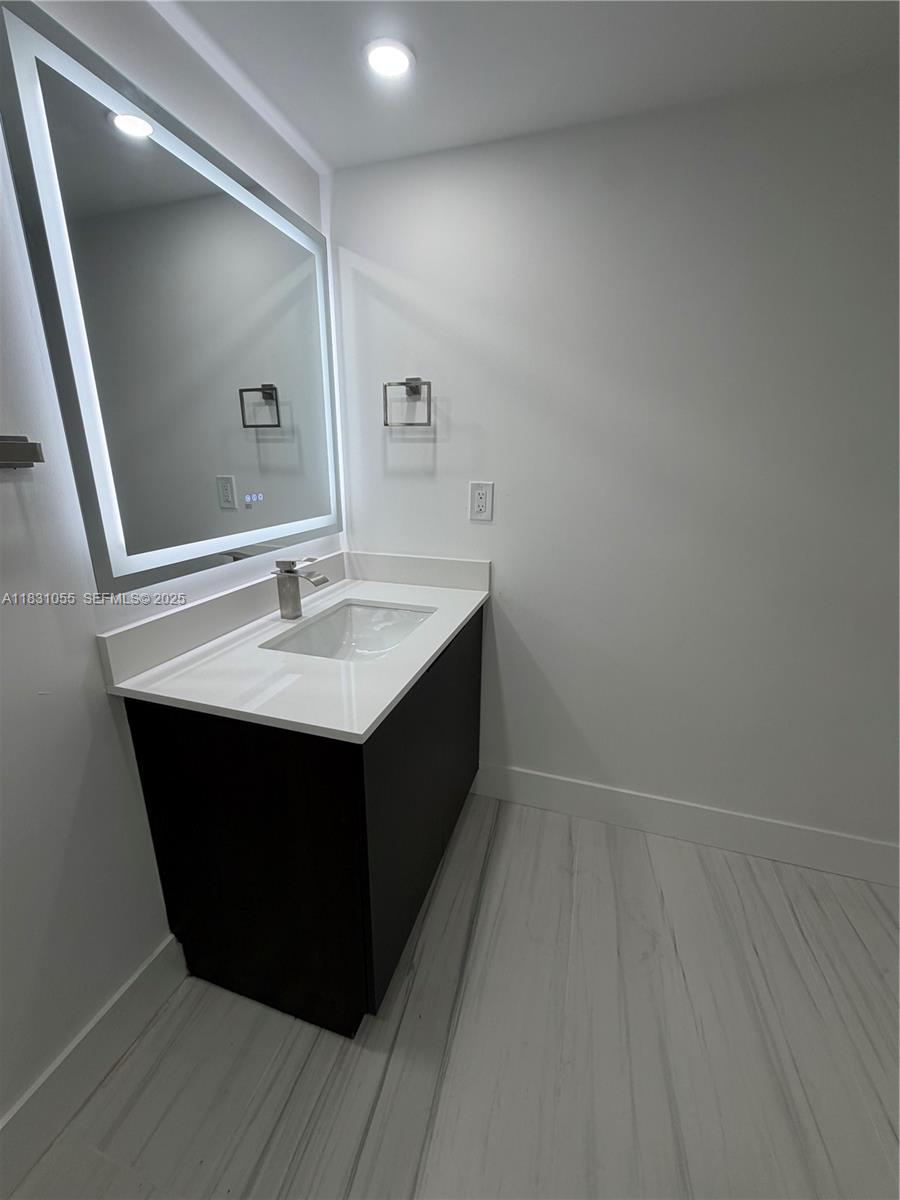 16251 Golf Club Road, Unit 204 Weston, FL 33326 - Photo 19 of 40 a kitchen with a sink vanity and mirror