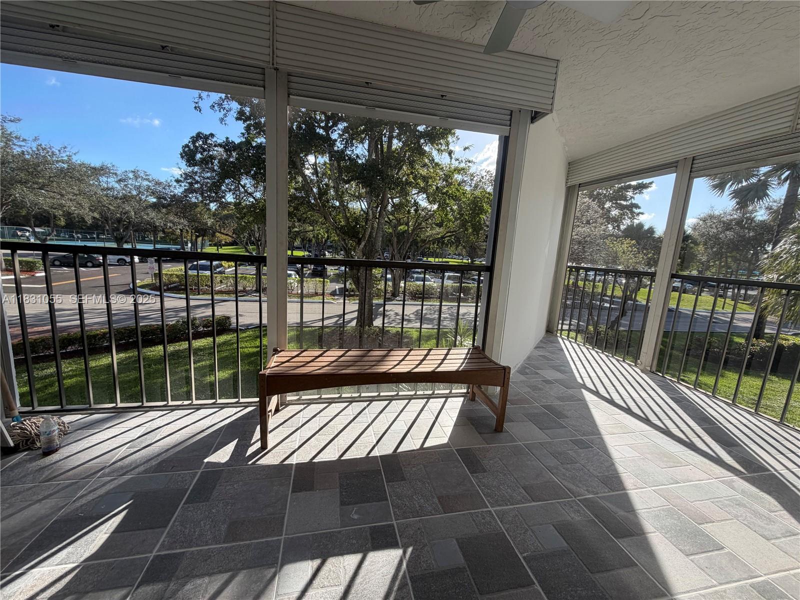 16251 Golf Club Road, Unit 204 Weston, FL 33326 - Photo 23 of 40 a view of a balcony with wooden floor