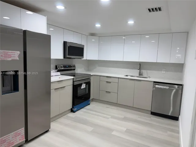 a kitchen with a stove and a microwave
