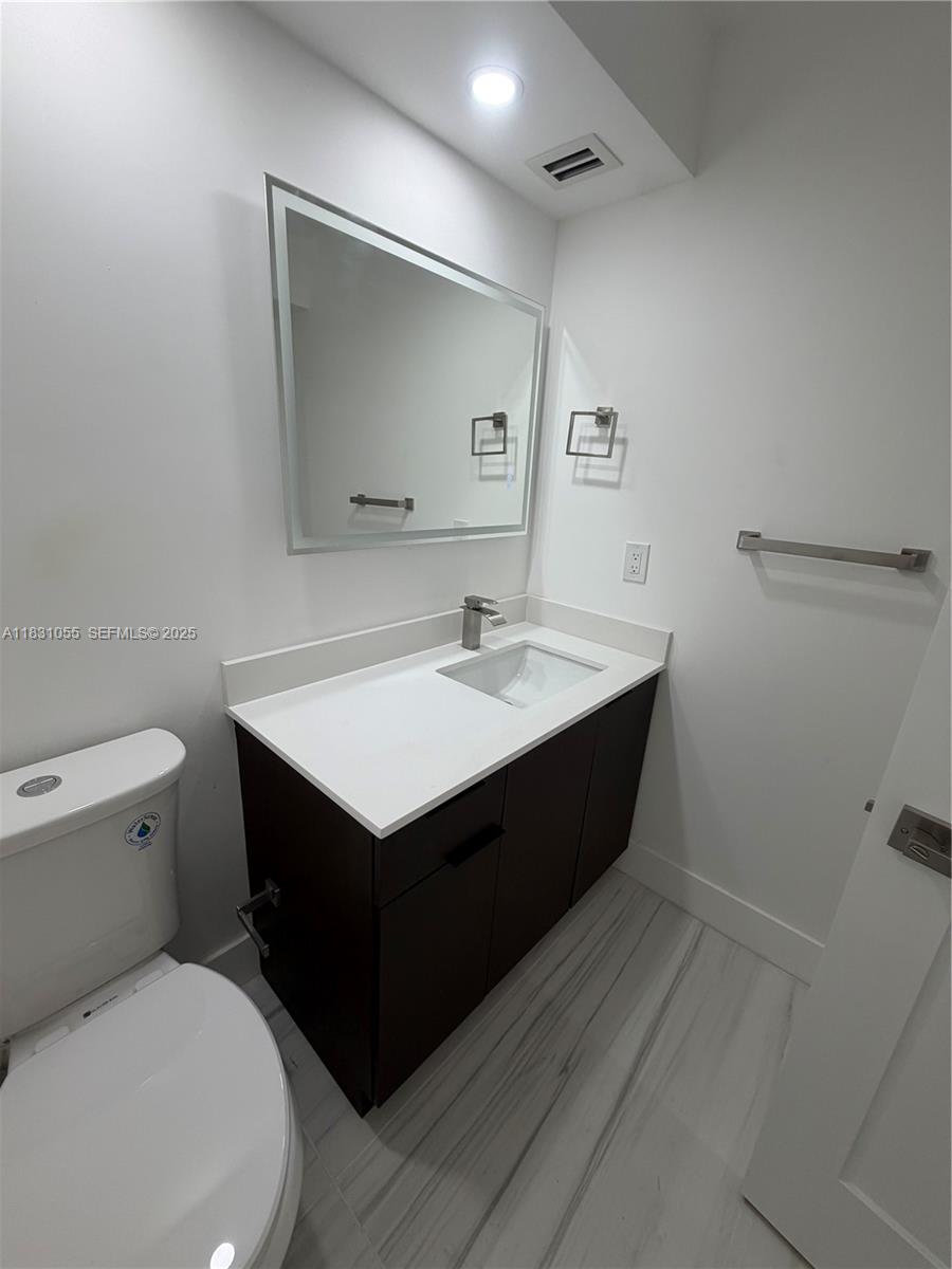 16251 Golf Club Road, Unit 204 Weston, FL 33326 - Photo 7 of 40 a bathroom with a sink toilet and mirror