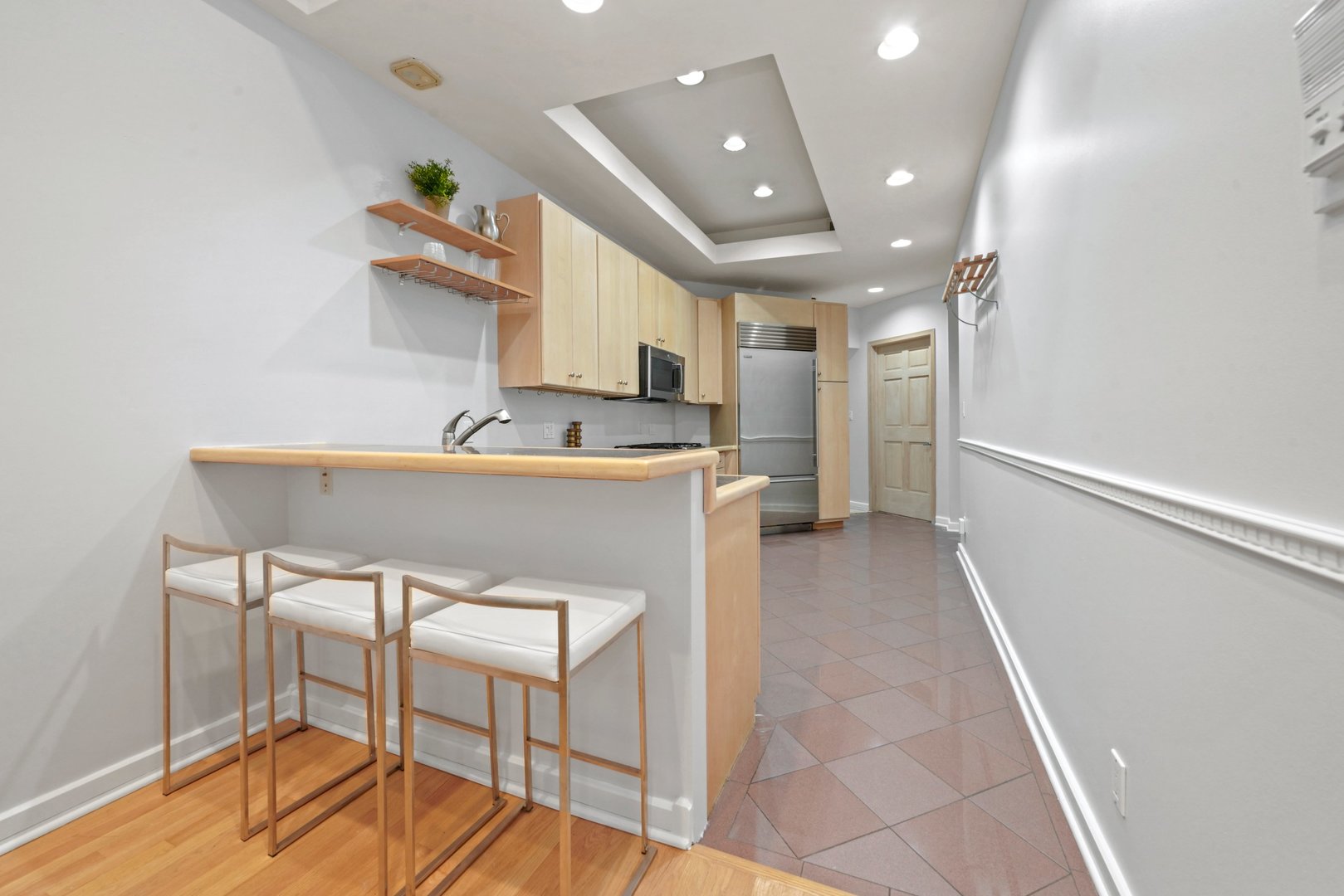 1407 North Mohawk Street, Unit 3 Chicago, IL 60610 - Photo 6 of 19 a kitchen with kitchen island a table and chairs in it