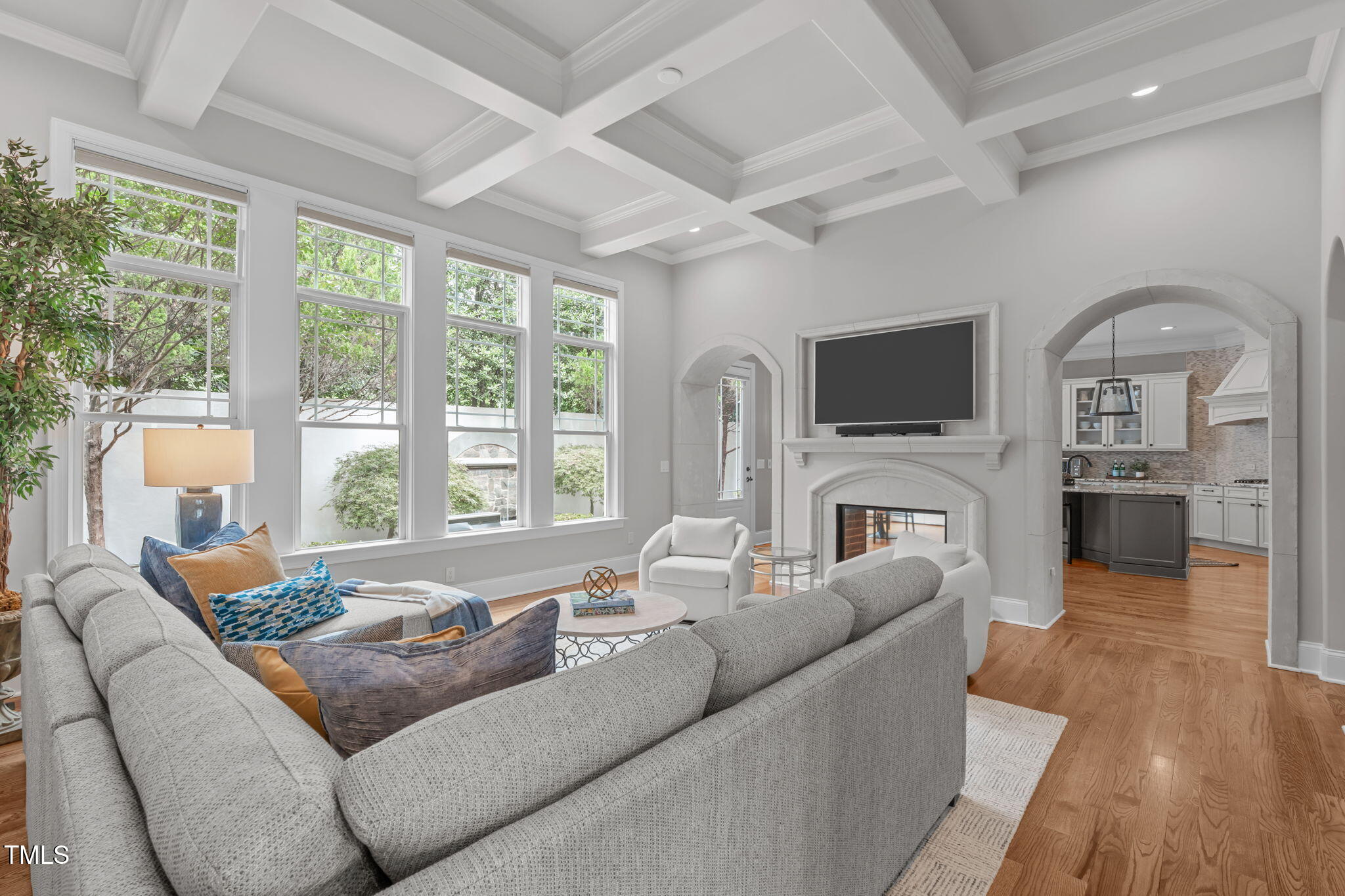 2612 Shadow Hills Court Raleigh, NC 27612 - Photo 16 of 63 a living room with furniture a fireplace and a flat screen tv