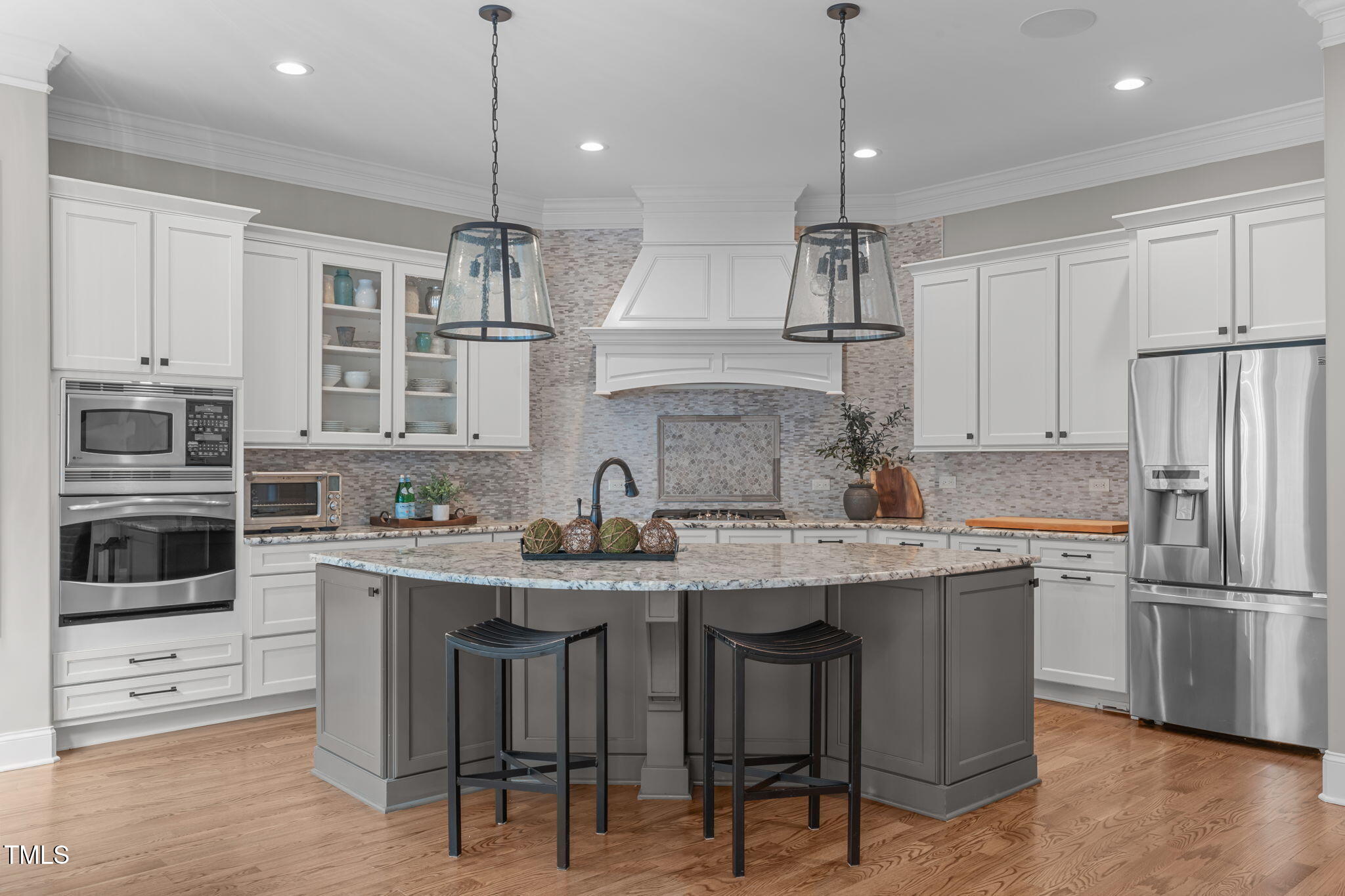 2612 Shadow Hills Court Raleigh, NC 27612 - Photo 19 of 63 a kitchen with stainless steel appliances granite countertop a sink a stove a refrigerator and microwave with wooden floor