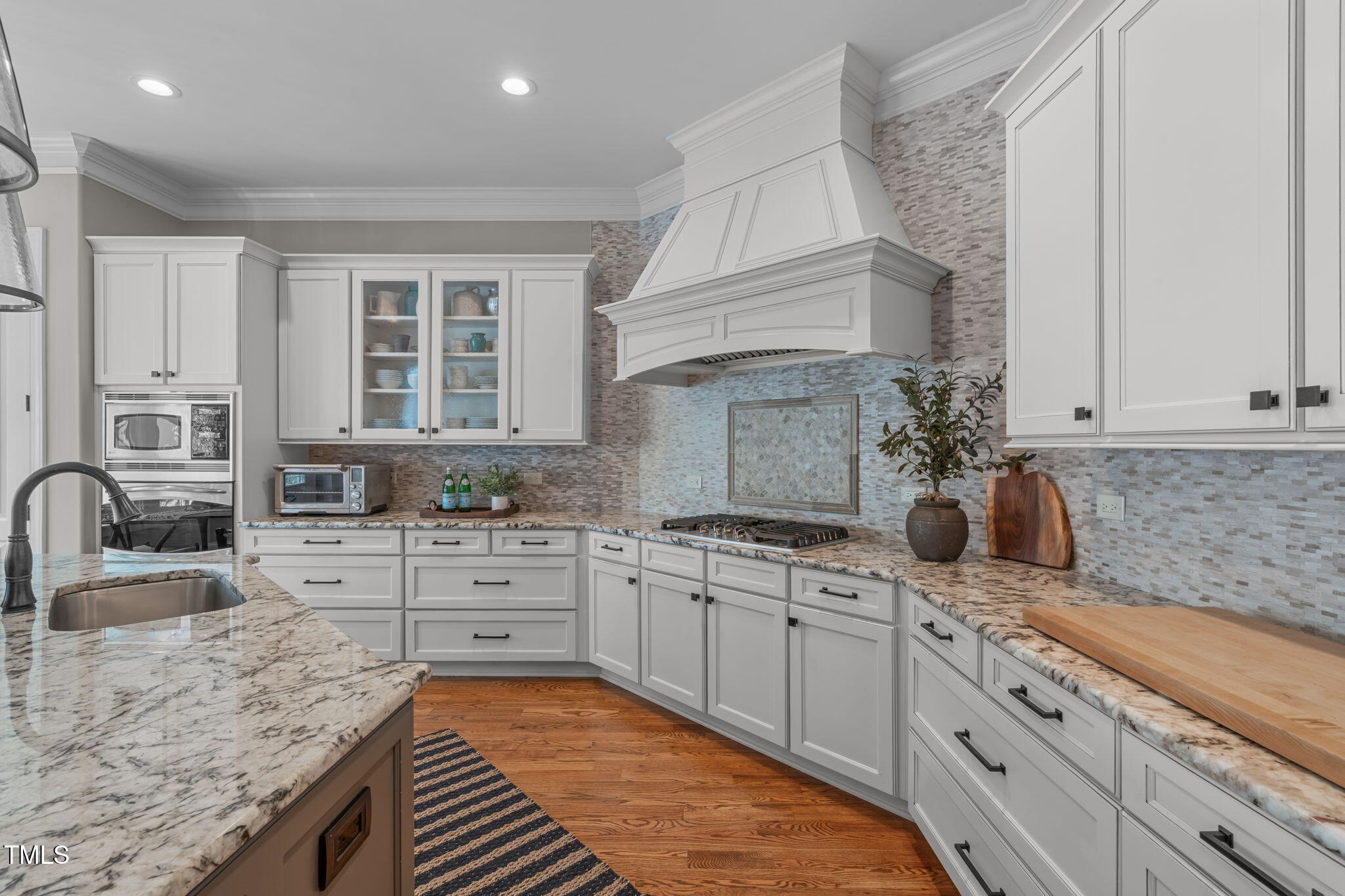 2612 Shadow Hills Court Raleigh, NC 27612 - Photo 23 of 63 a kitchen with sink stove and cabinets