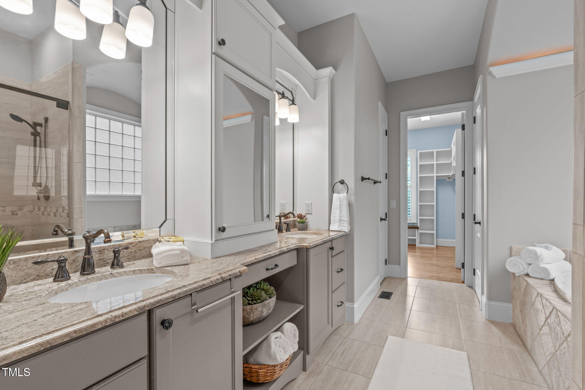 2612 Shadow Hills Court Raleigh, NC 27612 - Photo 32 of 63 a spacious bathroom with a granite countertop sink and a mirror