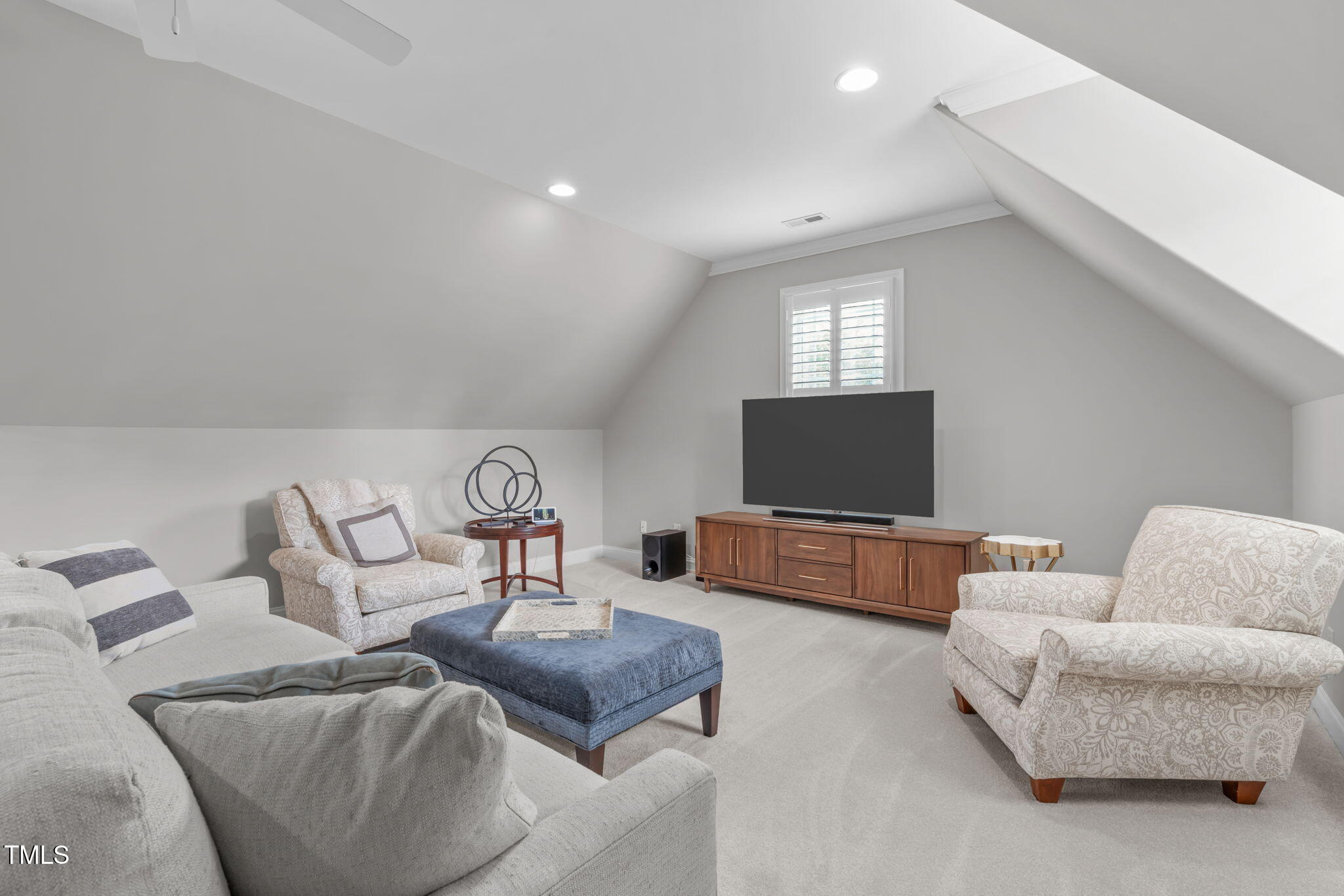 2612 Shadow Hills Court Raleigh, NC 27612 - Photo 42 of 63 a living room with furniture and a flat screen tv