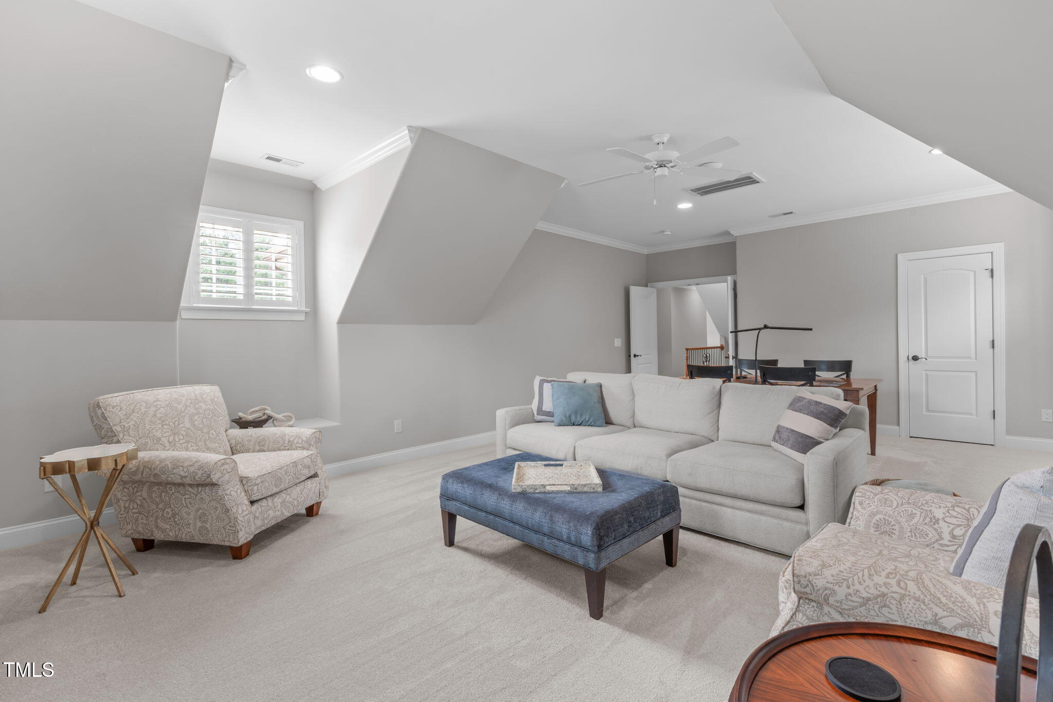 2612 Shadow Hills Court Raleigh, NC 27612 - Photo 43 of 63 a living room with furniture and a chandelier