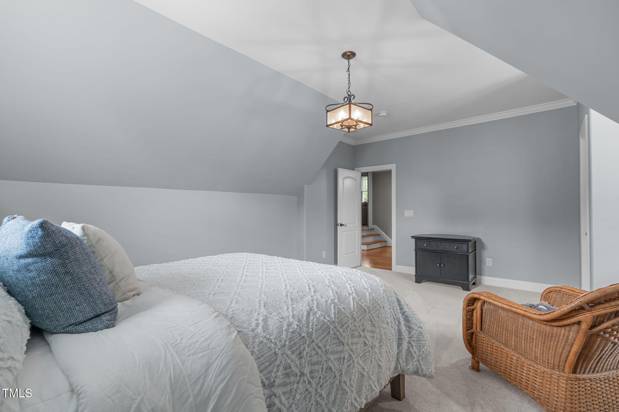 2612 Shadow Hills Court Raleigh, NC 27612 - Photo 45 of 63 a bedroom with a bed and a chandelier