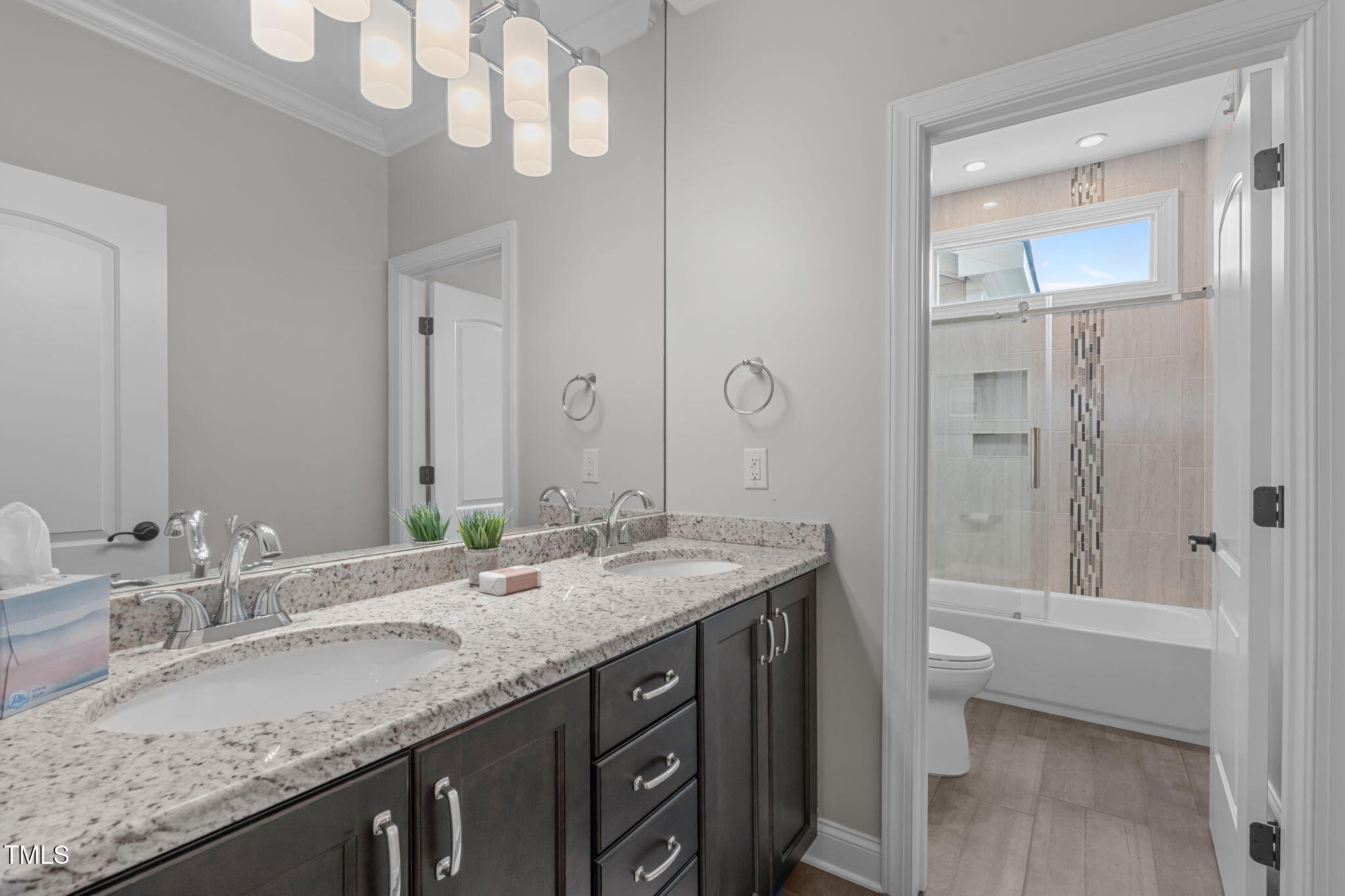 2612 Shadow Hills Court Raleigh, NC 27612 - Photo 46 of 63 a bathroom with a granite countertop sink a toilet and a large mirror