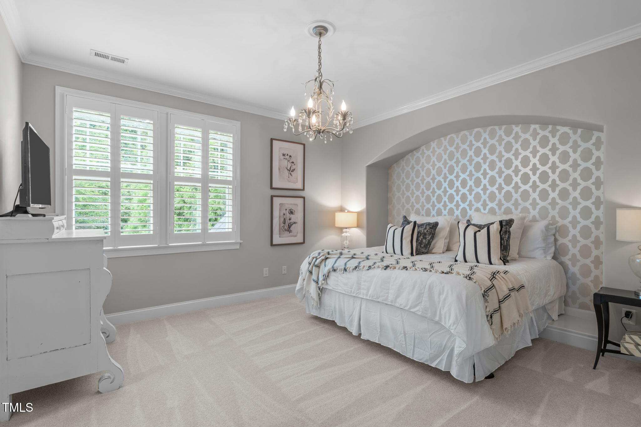 2612 Shadow Hills Court Raleigh, NC 27612 - Photo 50 of 63 a bedroom with a large bed chandelier and a large window