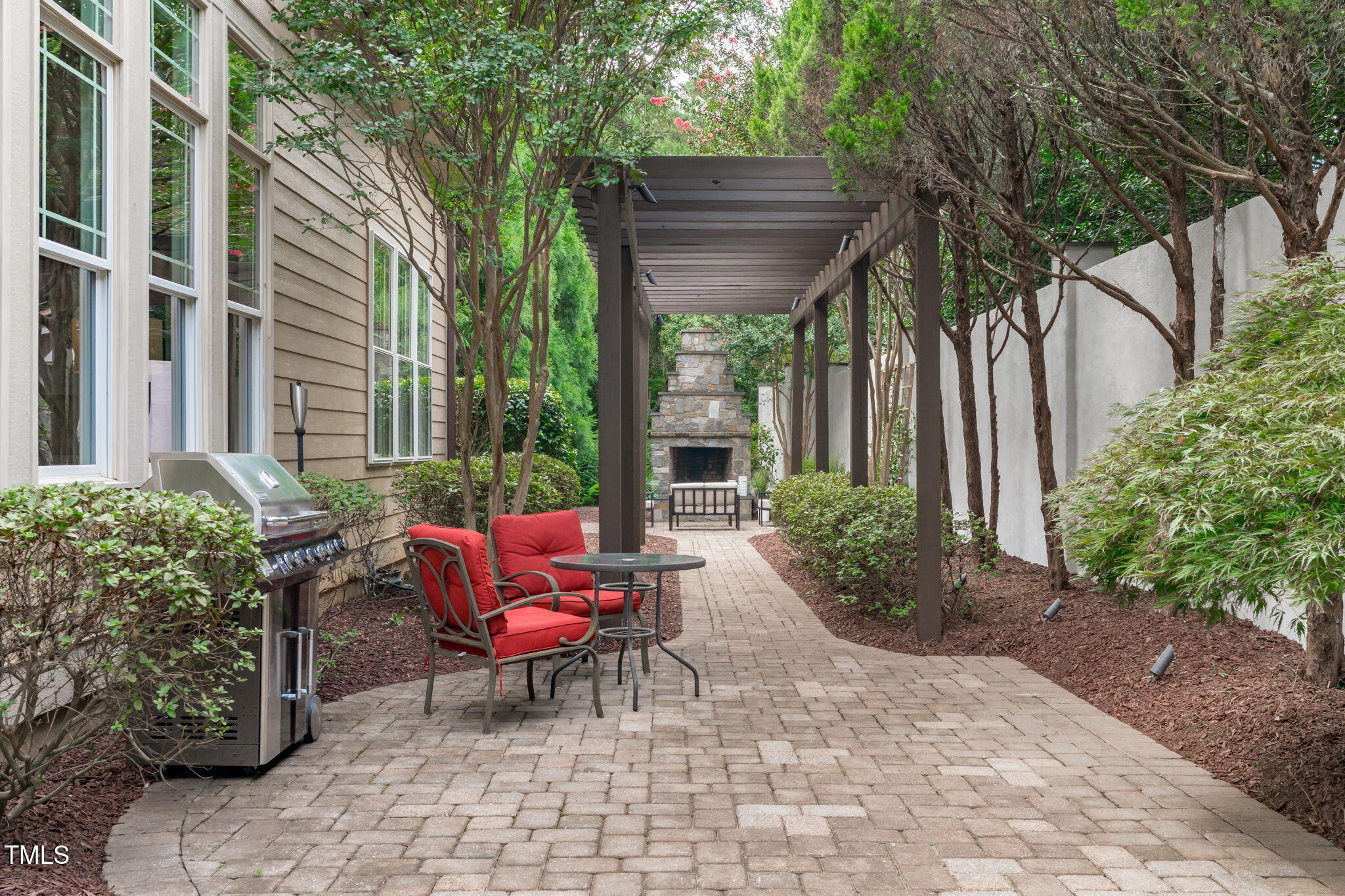 2612 Shadow Hills Court Raleigh, NC 27612 - Photo 59 of 63 a view of a chairs and table in the back yard of the house