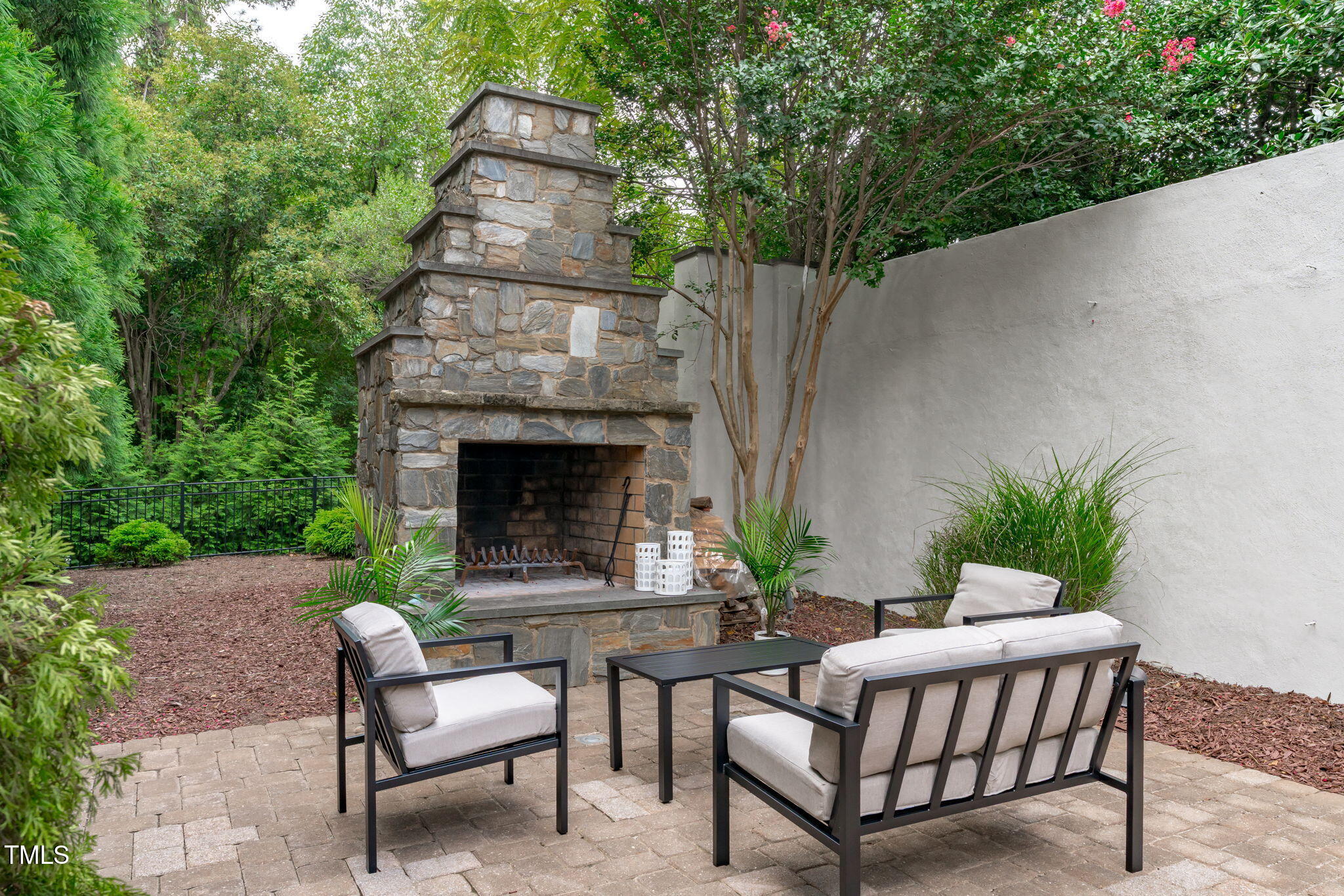 2612 Shadow Hills Court Raleigh, NC 27612 - Photo 61 of 63 a backyard of a house with table and chairs