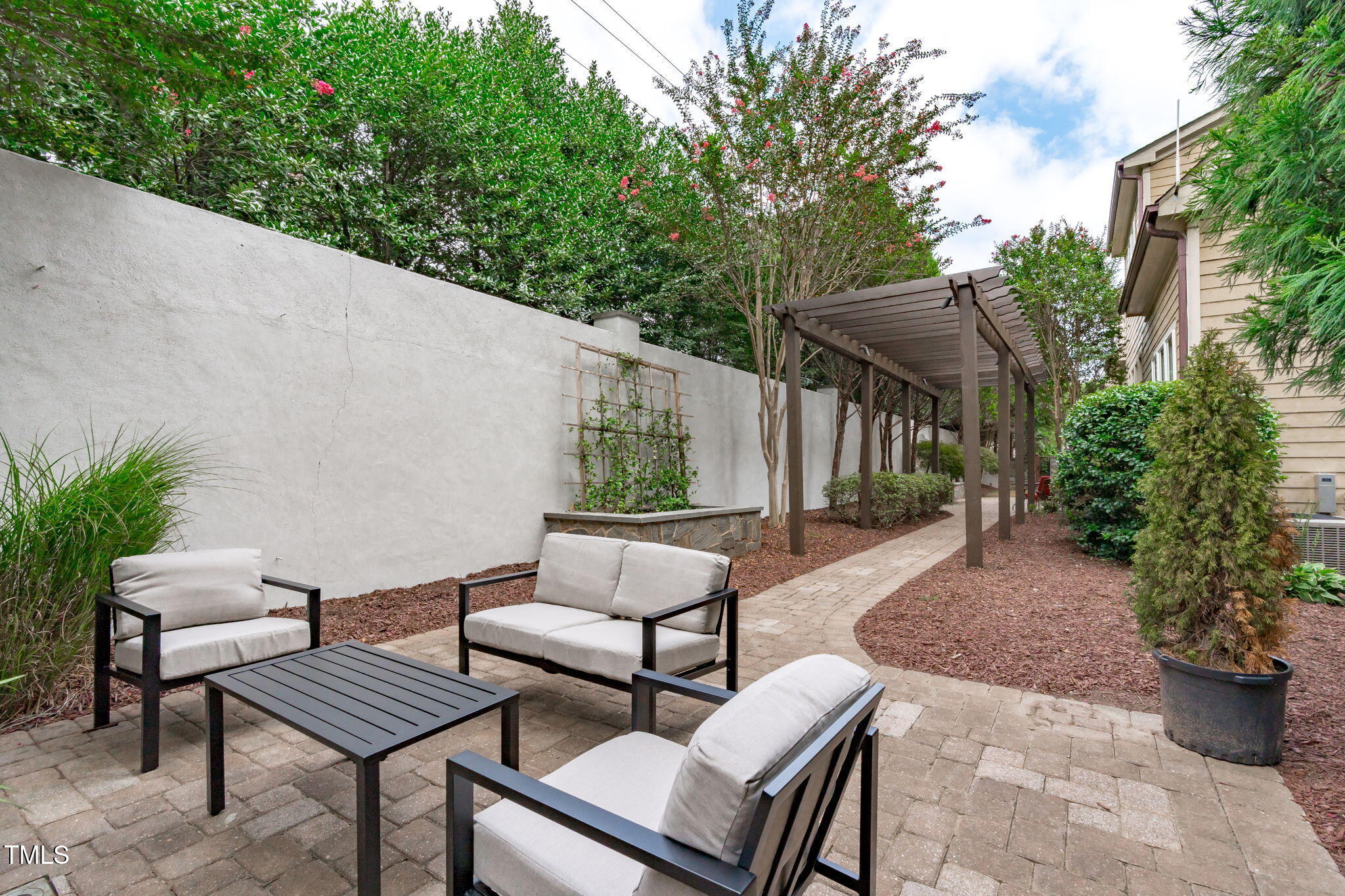2612 Shadow Hills Court Raleigh, NC 27612 - Photo 62 of 63 a view of a patio with couches and potted plants
