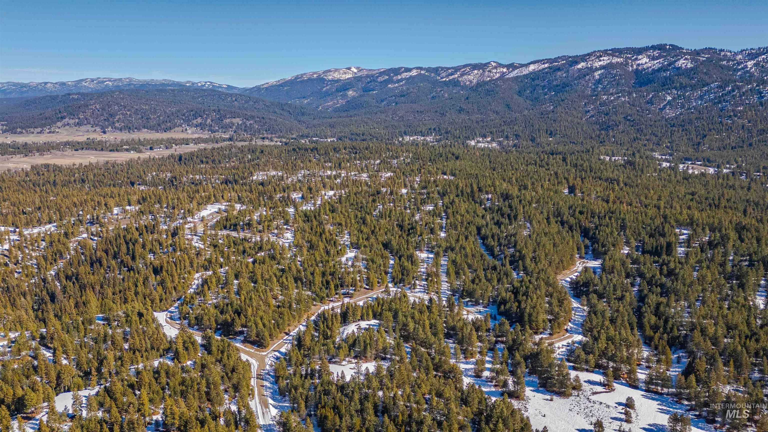 Tbd Skunk Creek Road Cascade, ID 83611 - Photo 12 of 36 Aerial overview of property's location with a mountain backdrop and a forest