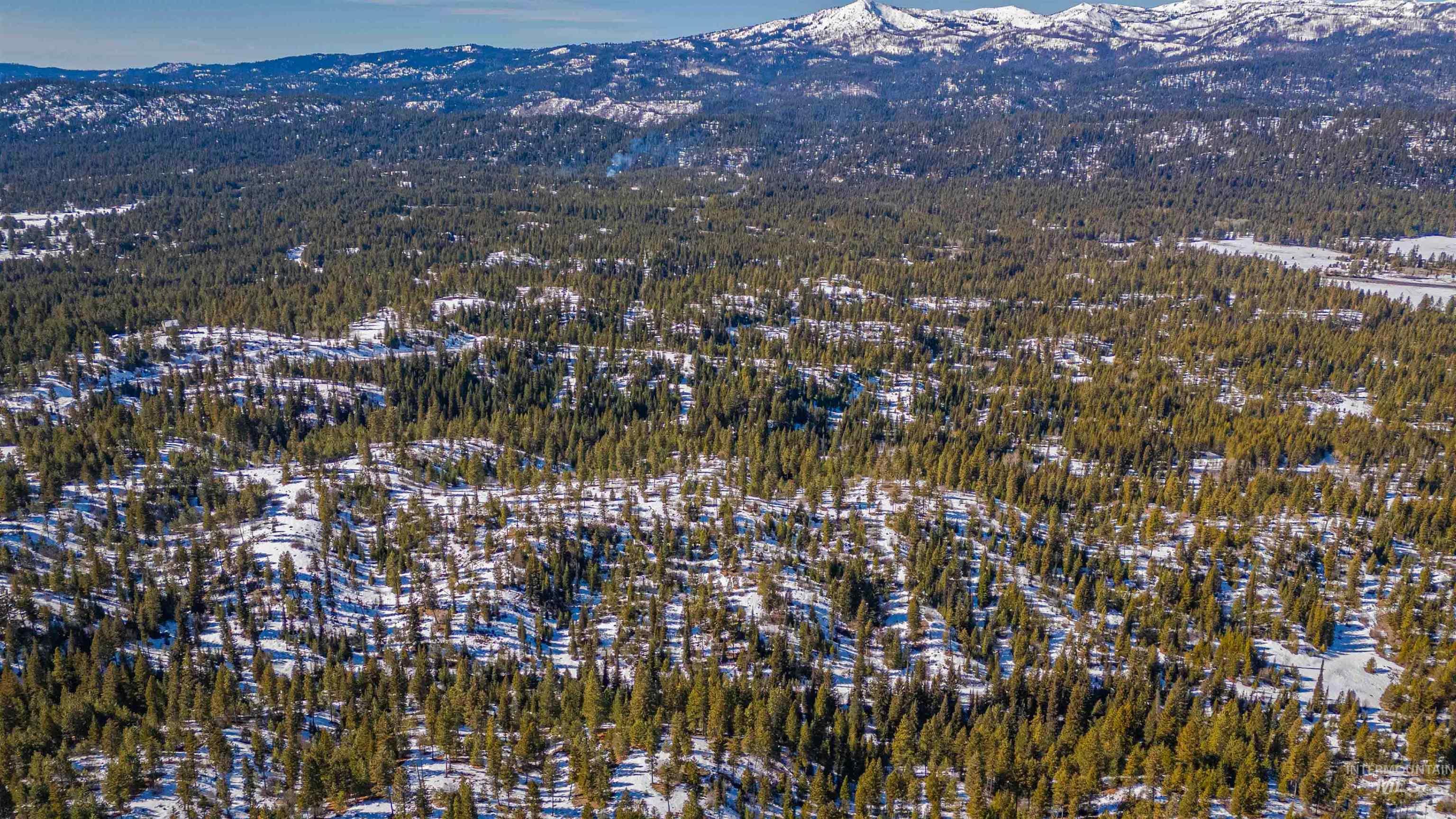 Tbd Skunk Creek Road Cascade, ID 83611 - Photo 18 of 36 Aerial view of property's location with mountains and a heavily wooded area