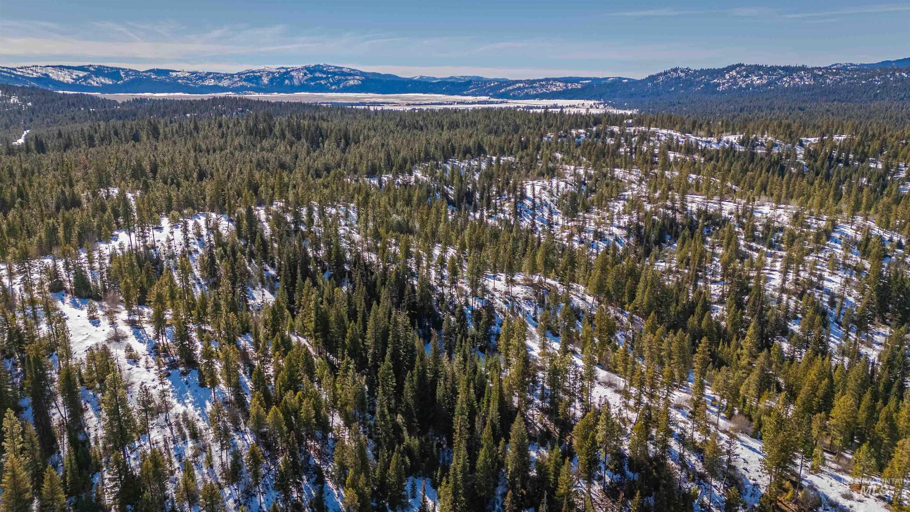 Tbd Skunk Creek Road Cascade, ID 83611 - Photo 20 of 36 Drone / aerial view of a mountainous background and a heavily wooded area