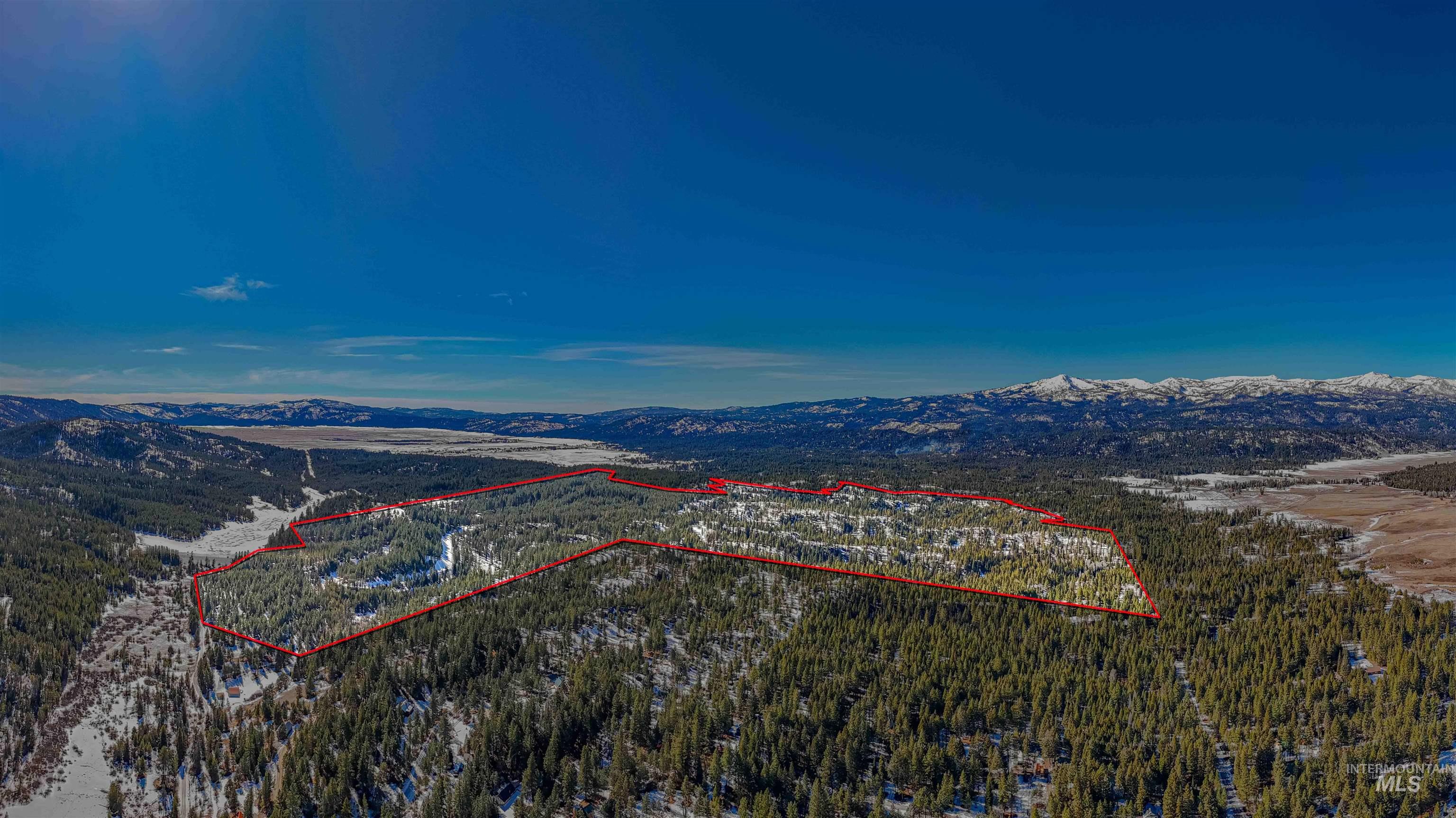 Tbd Skunk Creek Road Cascade, ID 83611 - Photo 22 of 36 Aerial view of property's location featuring a mountain backdrop and property boundaries highlighted