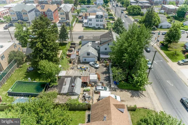 an aerial view of a house with a garden and trees