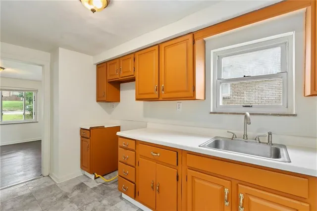 a kitchen with stainless steel appliances granite countertop sink and cabinets