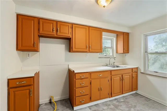 a utility room with sink dryer and washer
