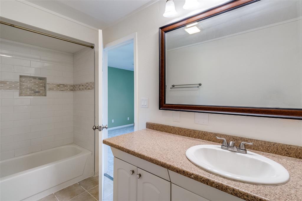 8404 Forest Lane, Unit 702 Dallas, TX 75243 - Photo 11 of 12 a bathroom with a sink and a bathtub