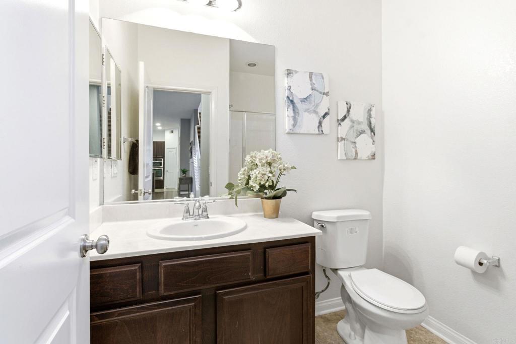1508 Carpinteria Street Chula Vista, CA 91913 - Photo 12 of 39 a bathroom with a sink toilet and mirror
