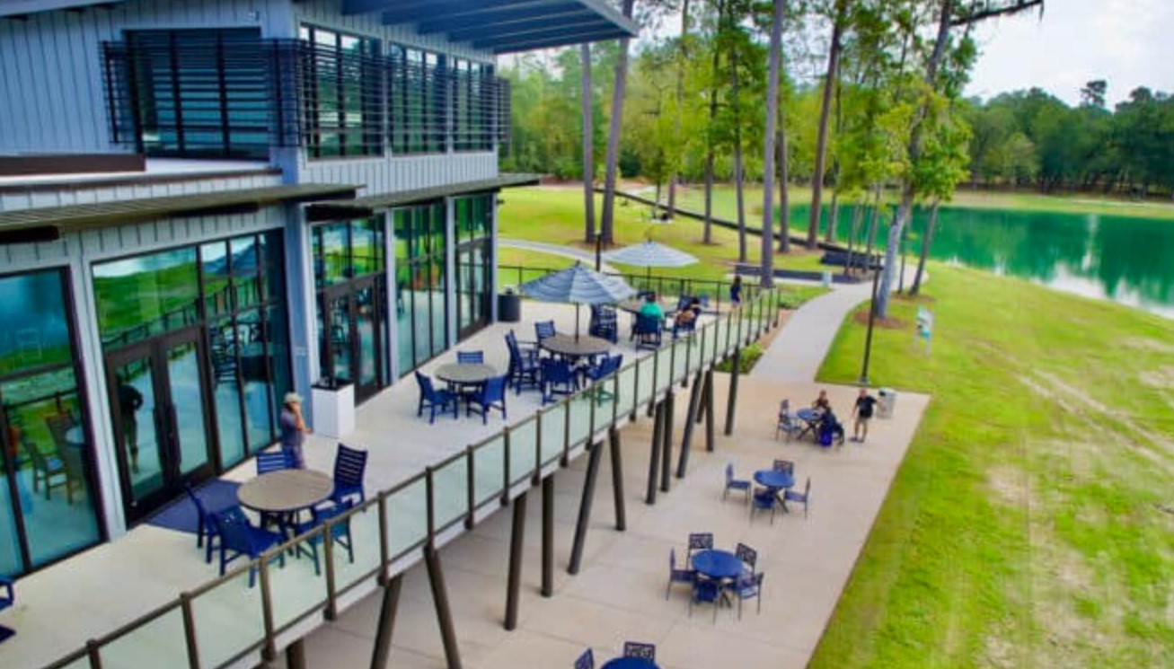 211 Sierra Strm Lane Conroe, TX 77304 - Photo 22 of 25 an outdoor sitting area with furniture and garden view