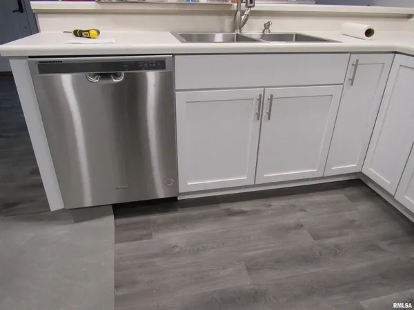 a view of a refrigerator in kitchen and a sink