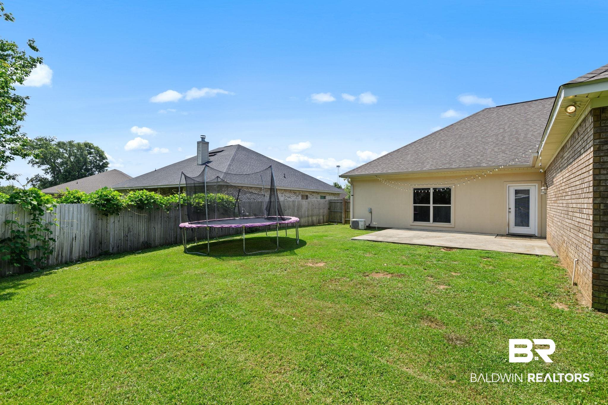 9730 Harmony Ridge Circle West Semmes, AL 36575 - Photo 34 of 38 View of yard with a trampoline, a patio, and cooling unit