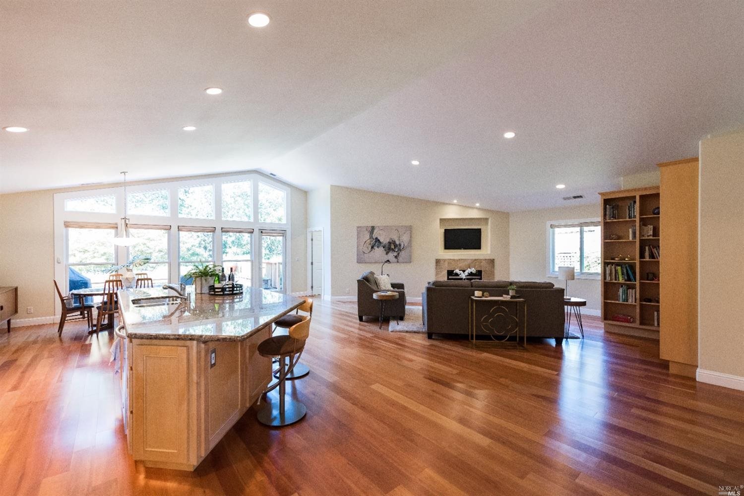 a living room with fireplace furniture and a wooden floor