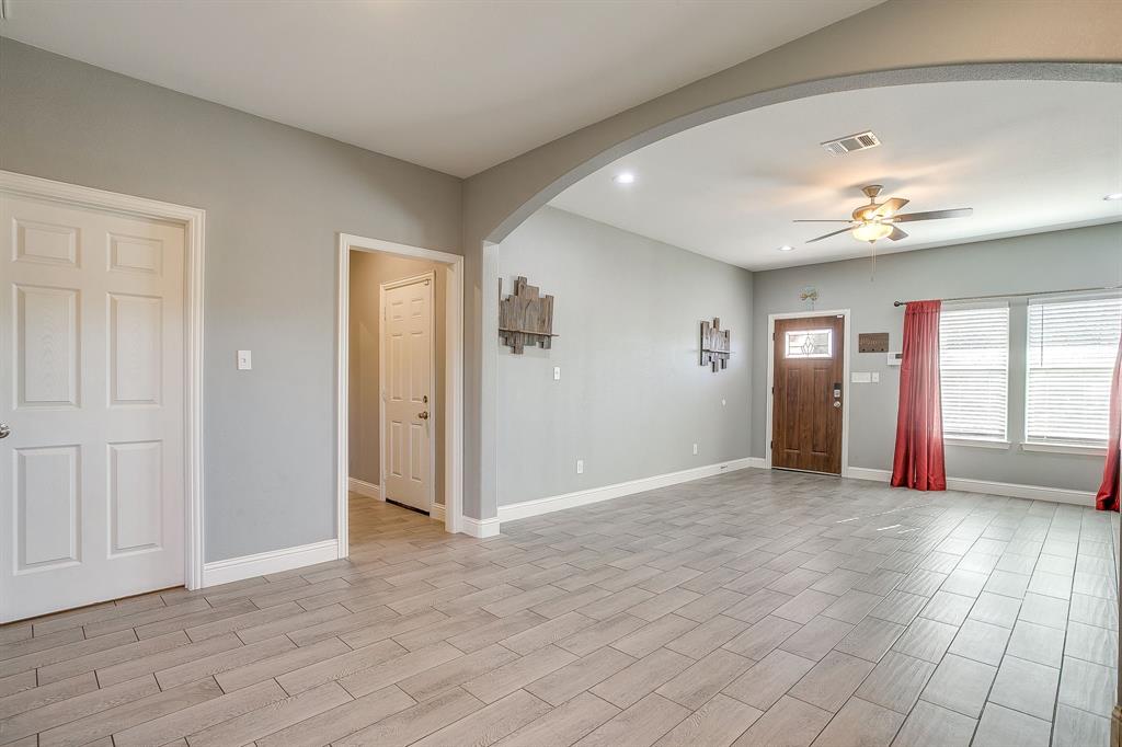 3901 Baylor Street Fort Worth, TX 76119 - Photo 16 of 40 an empty room with chandelier fan and windows
