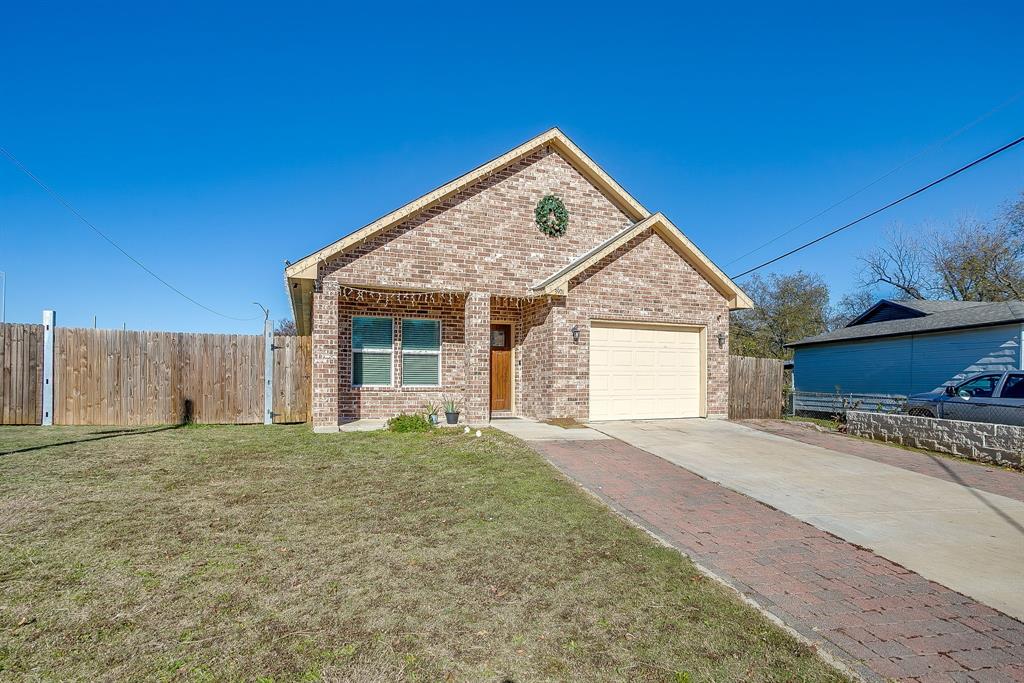 3901 Baylor Street Fort Worth, TX 76119 - Photo 2 of 40 a view of a house with a yard and garage