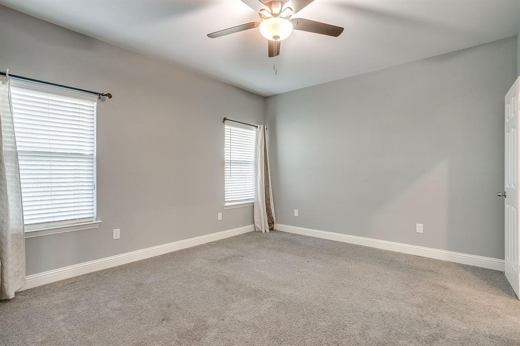 3901 Baylor Street Fort Worth, TX 76119 - Photo 23 of 40 an empty room with windows and chandelier fan