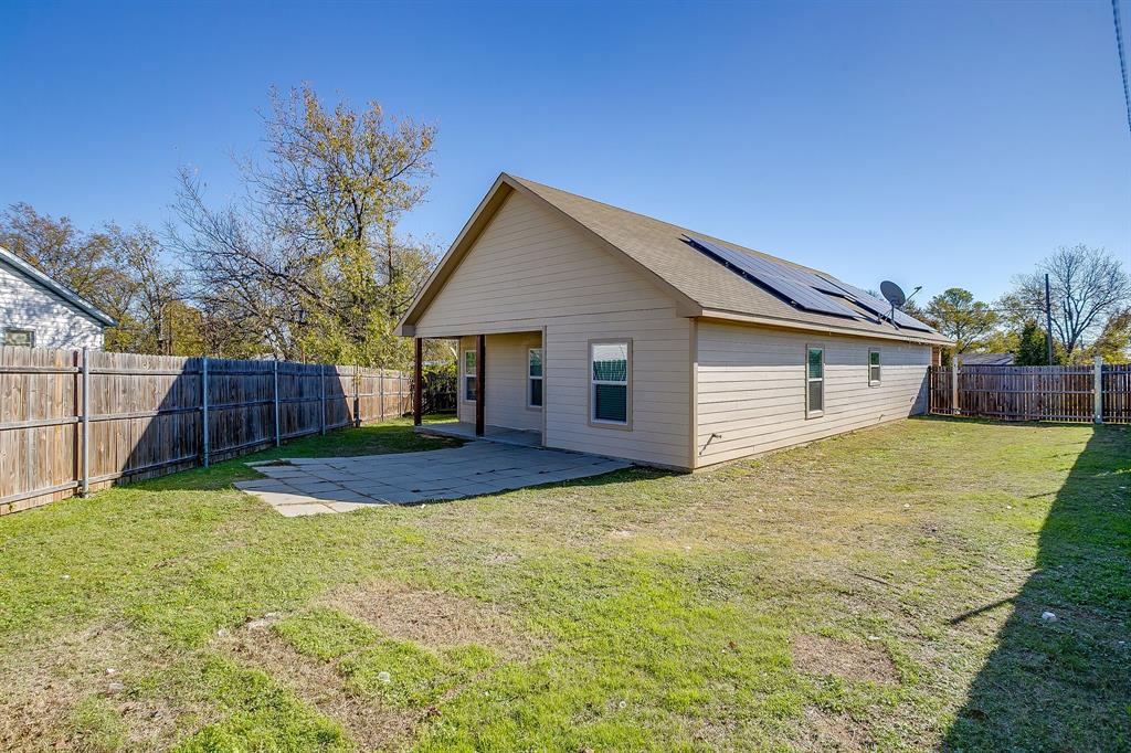 3901 Baylor Street Fort Worth, TX 76119 - Photo 38 of 40 a view of a house with a yard and wooden fence