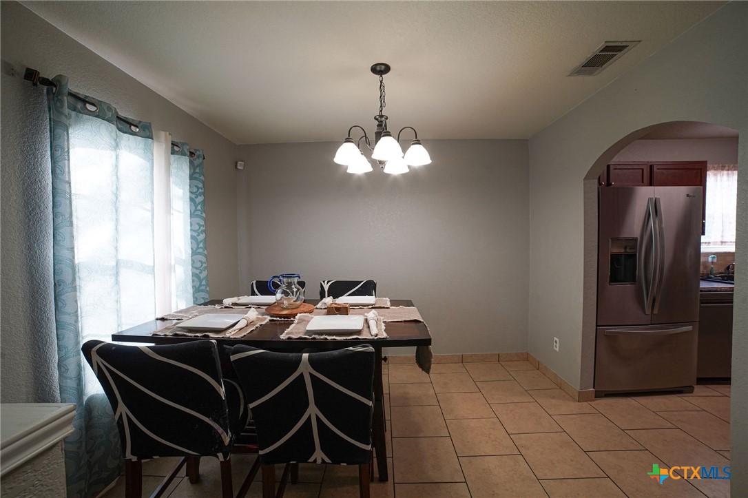 805 James Loop Killeen, TX 76542 - Photo 14 of 31 a dining room with chandelier and wooden floor