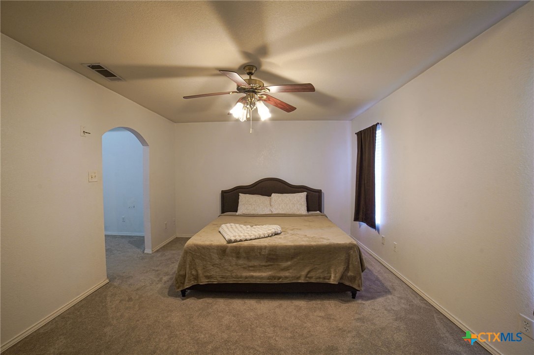 805 James Loop Killeen, TX 76542 - Photo 18 of 31 a bedroom with a bed and a chandelier