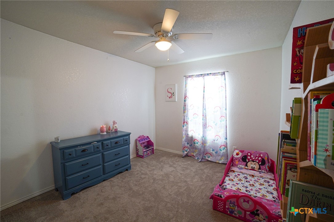 805 James Loop Killeen, TX 76542 - Photo 22 of 31 a bedroom with bed and a chandelier