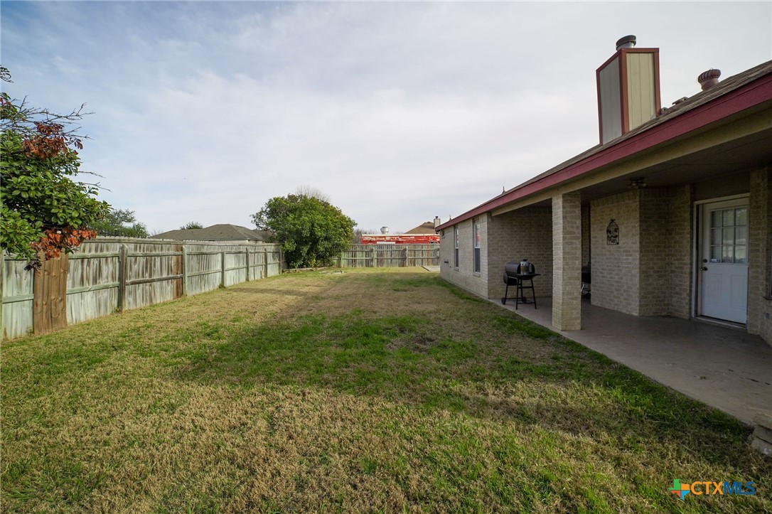 805 James Loop Killeen, TX 76542 - Photo 27 of 31 a view of backyard with barbeque grill and wooden fence