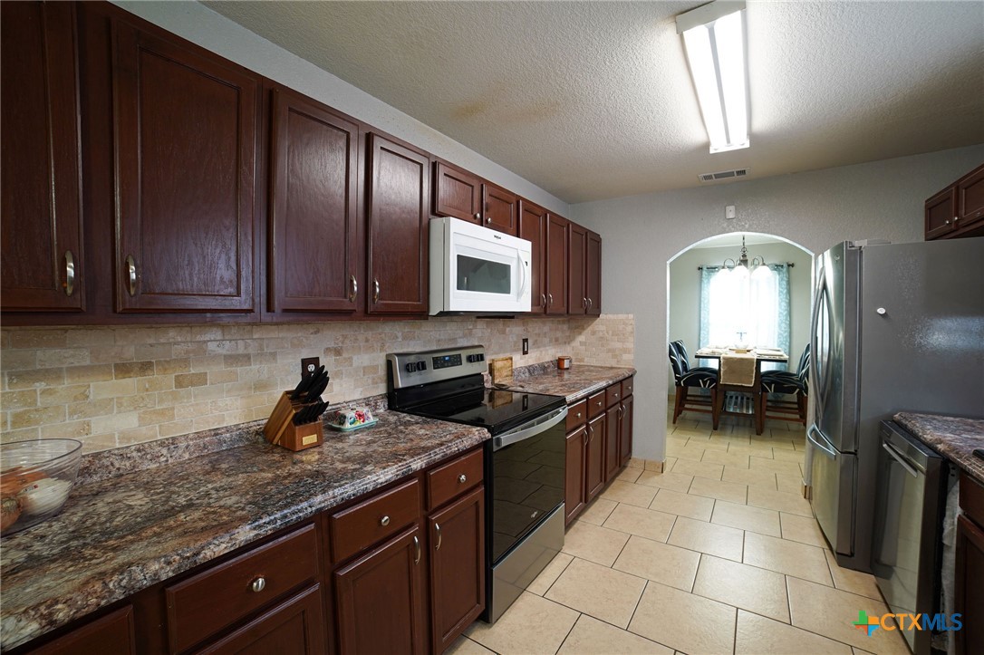 805 James Loop Killeen, TX 76542 - Photo 5 of 31 a kitchen with stainless steel appliances granite countertop a sink a stove counter space and cabinets