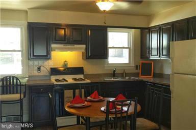 5601 Ranelagh Road White Marsh, MD 21162 - Photo 4 of 12 a kitchen with a table chairs sink and cabinets