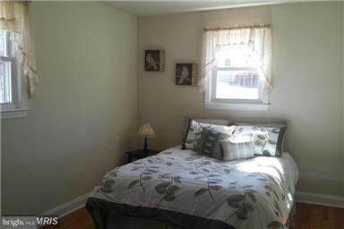 5601 Ranelagh Road White Marsh, MD 21162 - Photo 6 of 12 a bedroom with a bed and a window