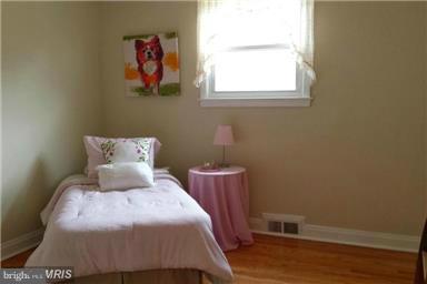 5601 Ranelagh Road White Marsh, MD 21162 - Photo 7 of 12 a bedroom with a bed and wooden floor