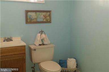 5601 Ranelagh Road White Marsh, MD 21162 - Photo 9 of 12 a white toilet sitting next to a bathroom sink