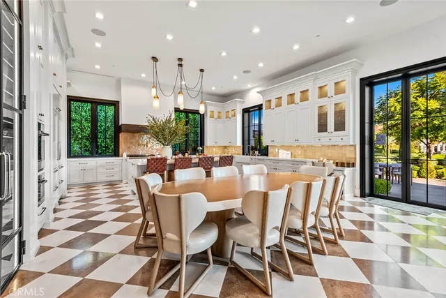 a very nice looking open dining room with a black and white checkered floor