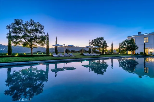 a view of swimming pool with outdoor space and lake view