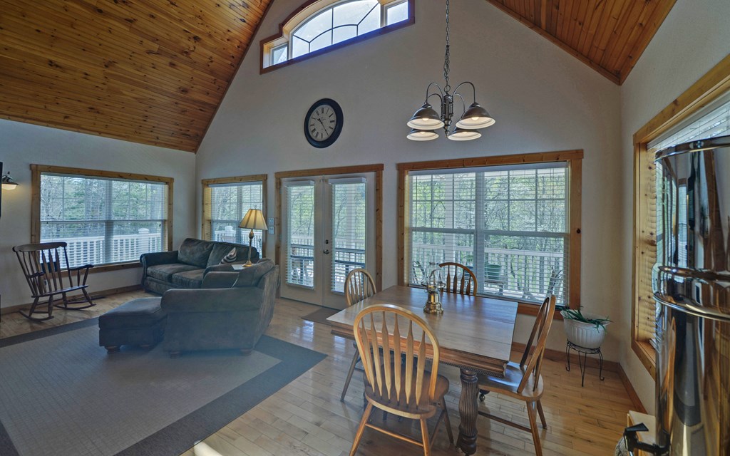 202 Dove Lane Morganton, GA 30560 - Photo 24 of 99 a view of a dining room with furniture large windows and a chandelier